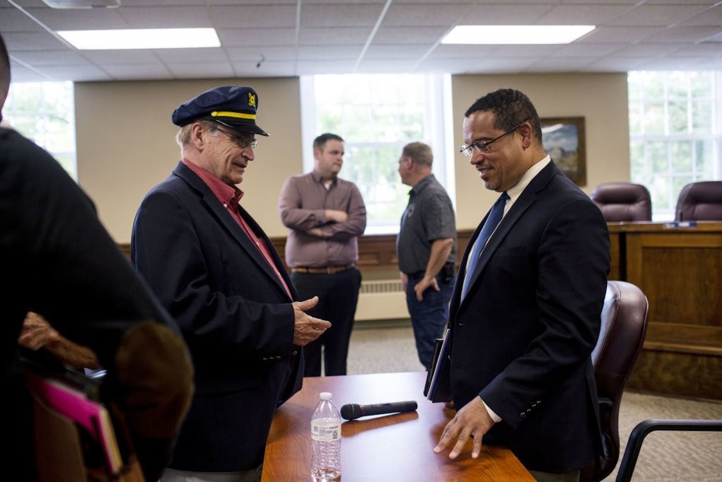 Attorney General Keith Ellison speaks to Minnesota House Rep. Bud Nornes after holding a public listening session in Fergus Falls city hall.