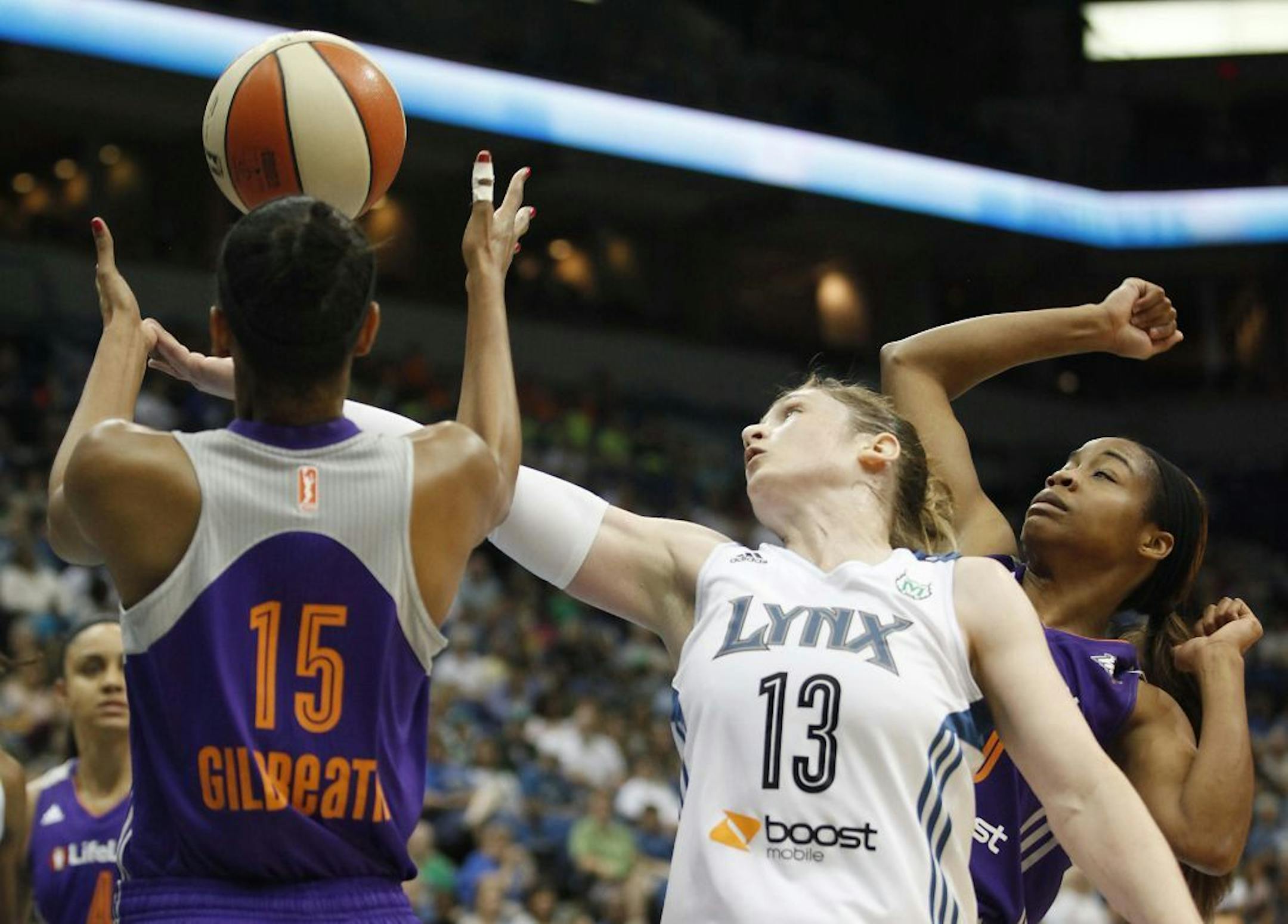 Minnesota Lynx guard Lindsay Whalen (13) tries to grab a rebound against Phoenix Mercury guard Briana Gilbreath (15) in the first half of a WNBA basketball game,