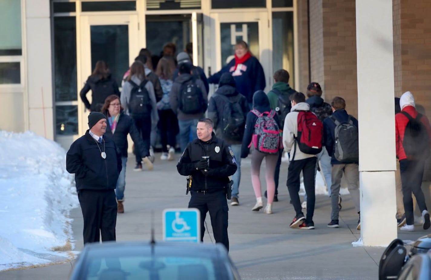 Police officers stand guard as Orono High School students arrive for the day Thursday, Feb. 22, 2018, a day after a threat was posted, causing the school to go on lockdown. A student was arrested at the high school Wednesday after a threat of gun violence.