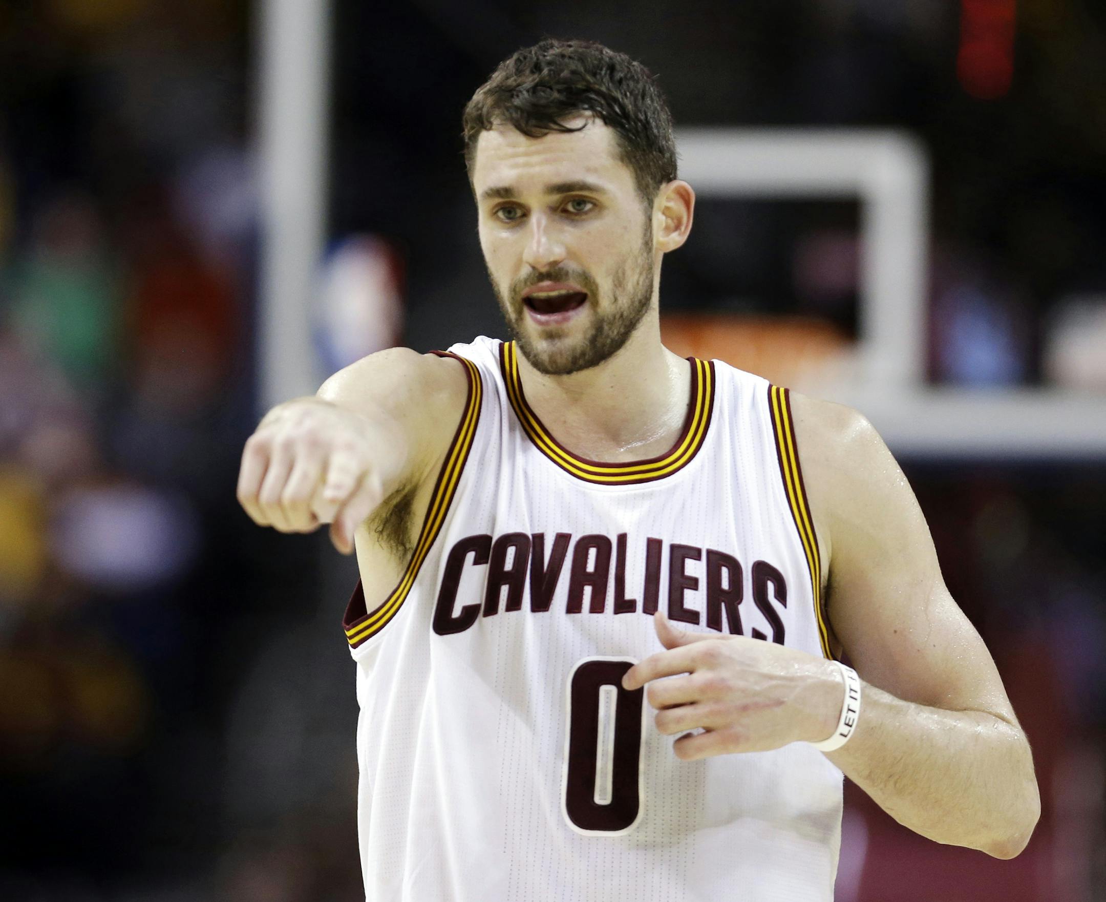 FILE - In this Jan. 28, 2015, file photo, Cleveland Cavaliers' Kevin Love talks with a teammate during an NBA basketball game against the Portland Trail Blazers in Cleveland. The surging Cleveland Cavaliers visit Minnesota on Saturday for the first time since they acquired Kevin Love from the Timberwolves in the summer blockbuster deal. (AP Photo/Tony Dejak, File)