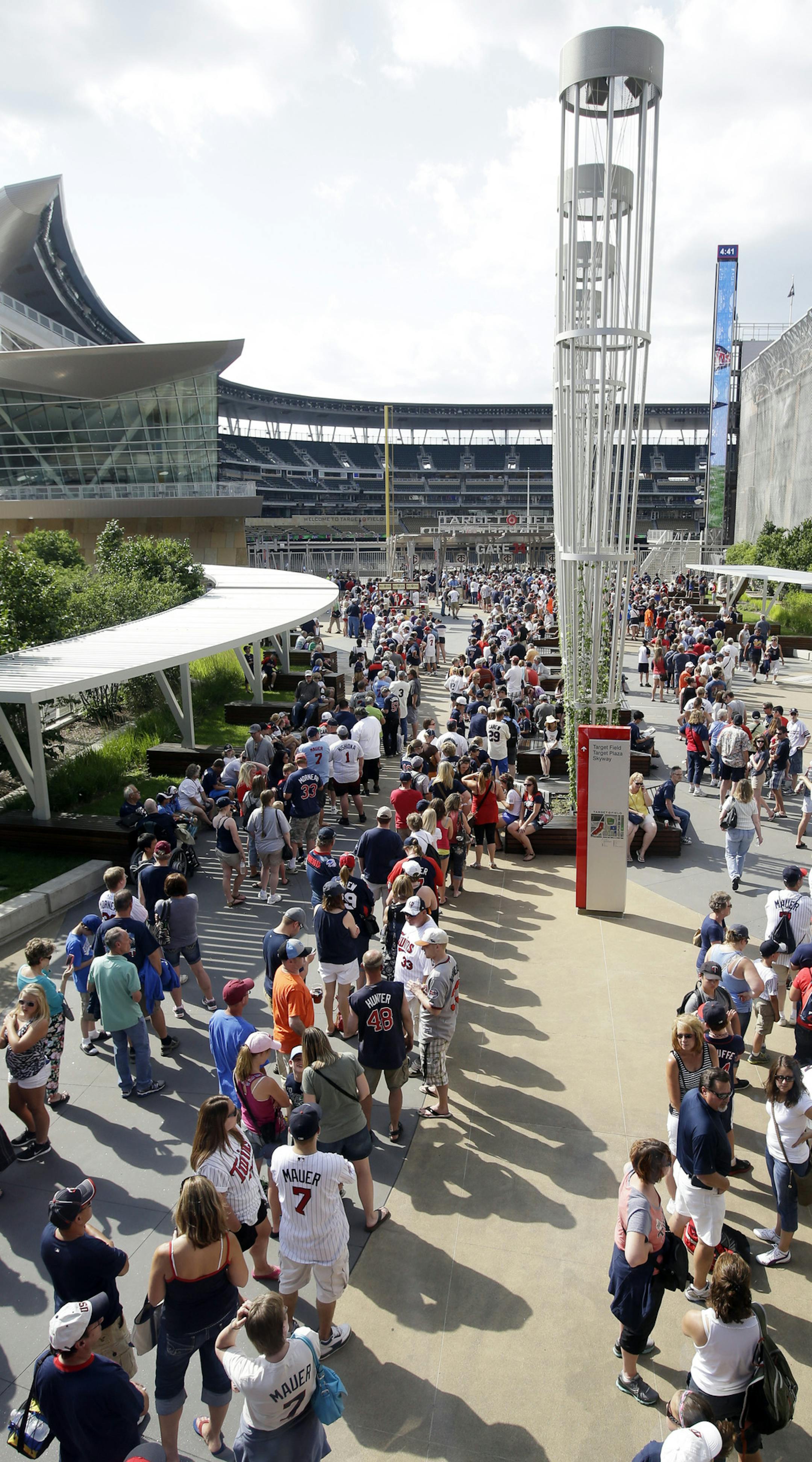Hundreds of fans line up outside Target Field as they wait for a chance to get Minnesota Twins' Joe Mauer and Justin Morneau bobbleheads prior to a baseball game against the Cleveland Indians, Friday, July 19, 2013 in Minneapolis. Target Field will be the site of the 2014 All-Star Game. (AP Photo/Jim Mone) ORG XMIT: MNJM10