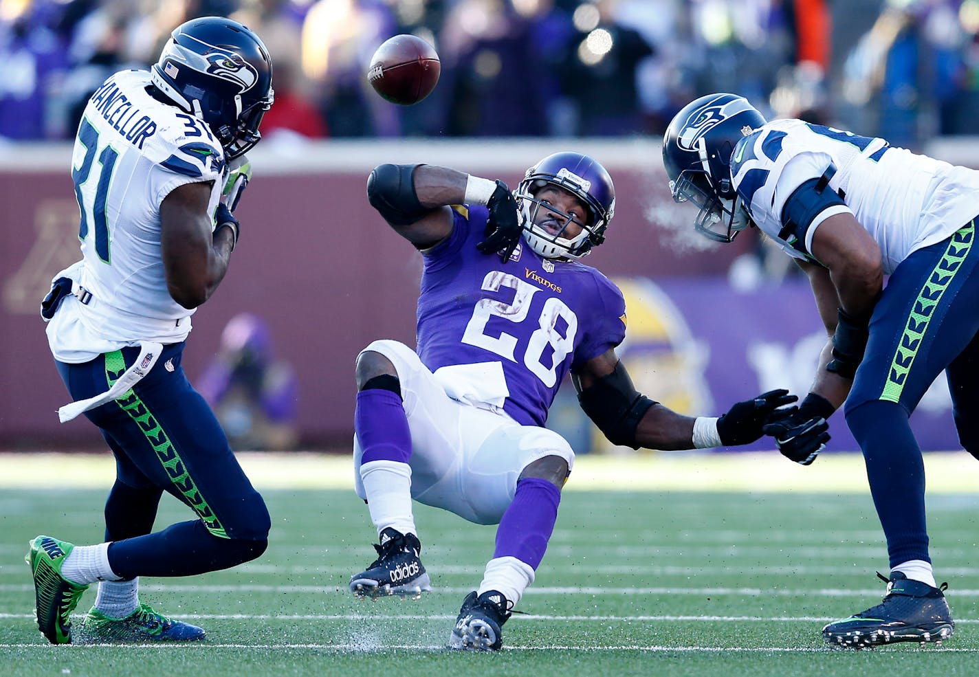 Kam Chancellor (31) stripped the ball away from Vikings running back Adrian Peterson (28) in the fourth quarter. ] CARLOS GONZALEZ � cgonzalez@startribune.com - January 10, 2016, Minneapolis, MN, TCF Bank Stadium, NFL, Minnesota Vikings vs. Seattle Seahawks