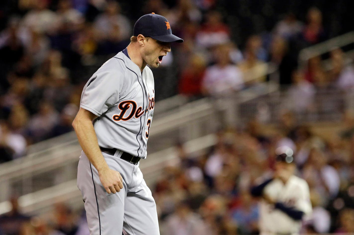 Detroit Tigers pitcher Max Scherzer reacts after he struck out Minnesota Twins' Josmil Pinto to end the first inning of a baseball game, Wednesday, Sept. 25, 2013, in Minneapolis. (AP Photo/Jim Mone)