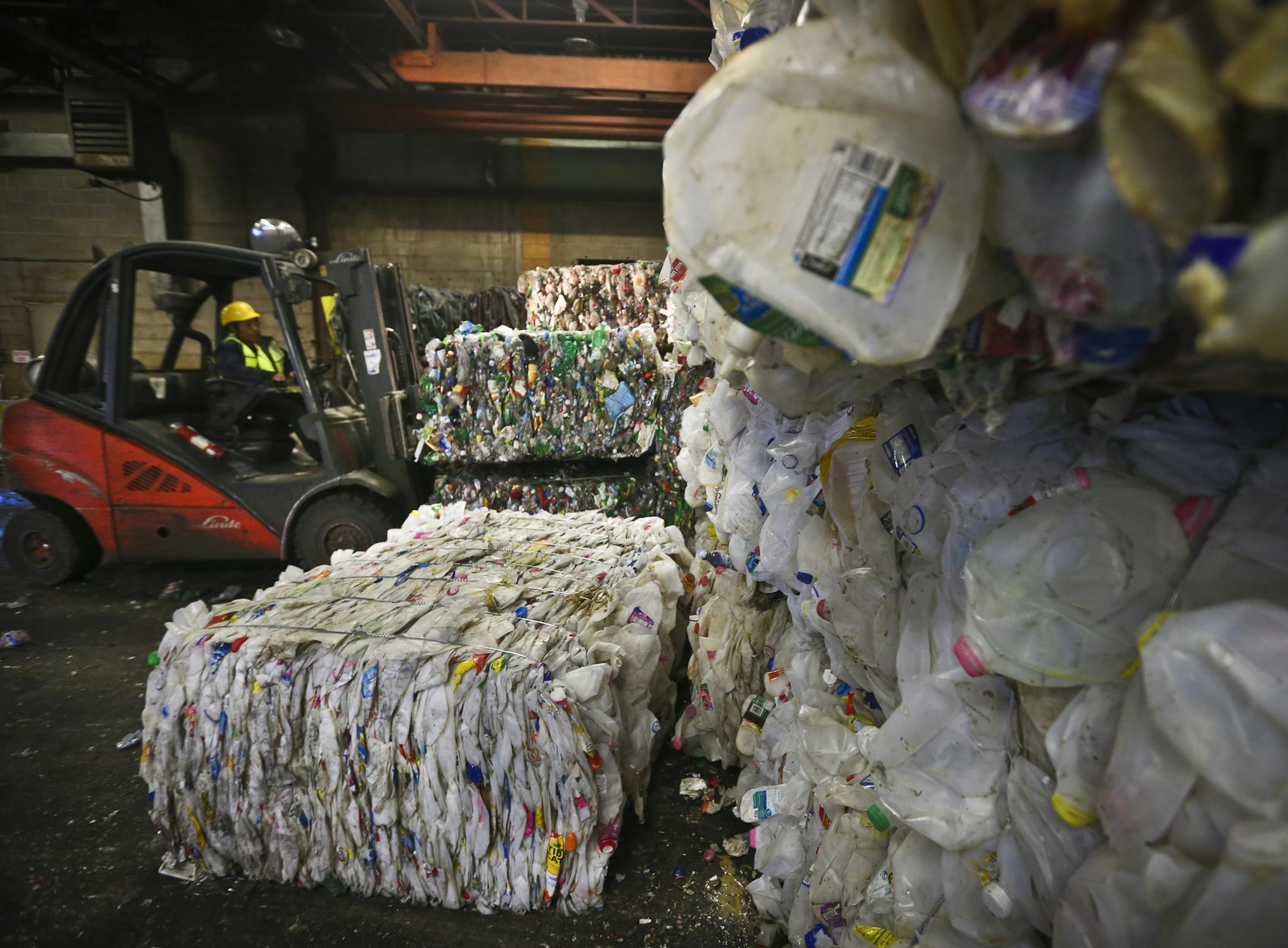 Eureka Recycling equipment operator Marcella Ramirez moved a load of plastic bottles Friday. More and more plastic is being sent to landfills rather than recycling plants, a study showed.