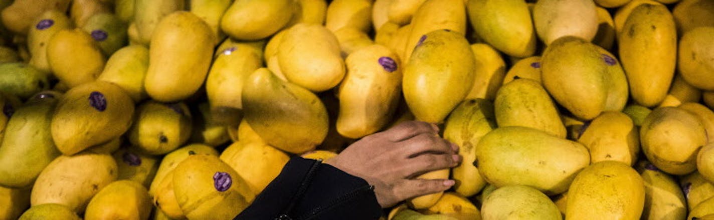 A customer reaches for mangos at the Whole Foods Market at Columbus Circle in New York, April 19, 2017. A steward of pension funds and retirement accounts, Neuberger Berman has recently eschewed its nearly 80-year-old tactic of playing nice, turning instead to sounding out hedge funds about investing in Whole Foods Market and pressing for change. (John Taggart/The New York Times)