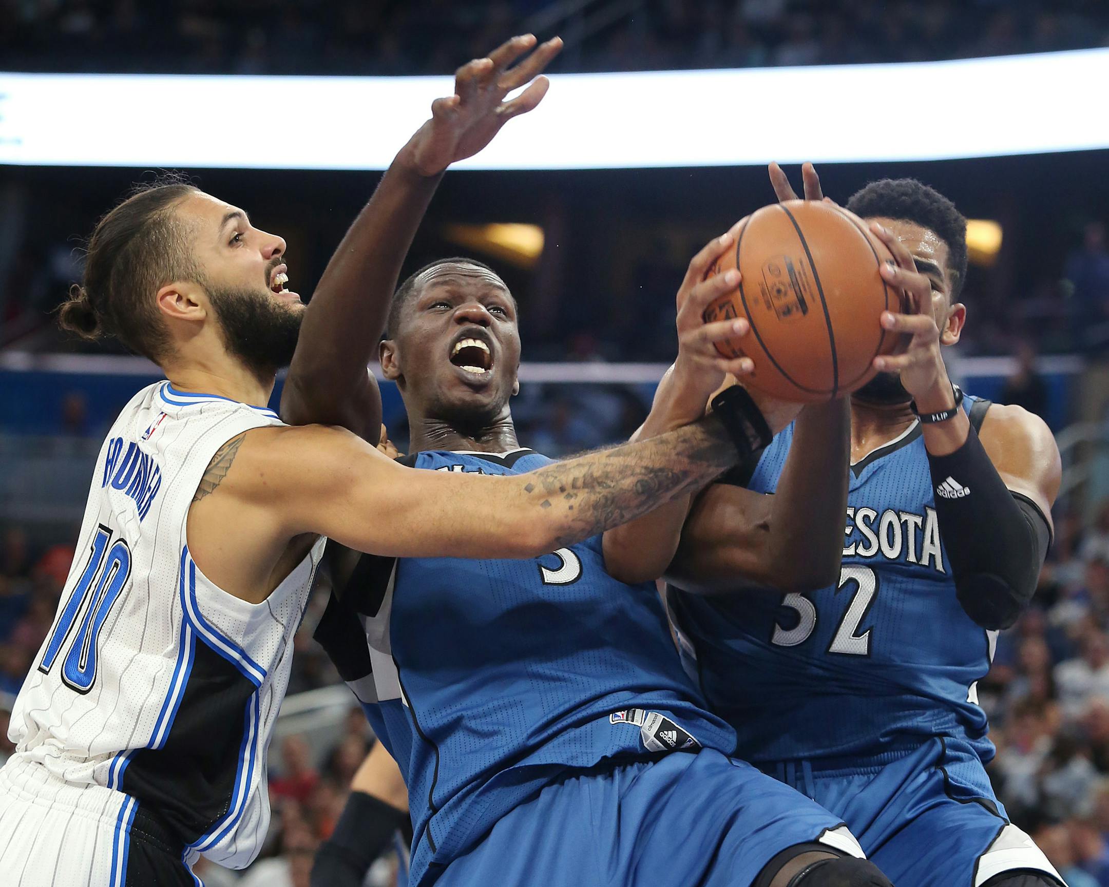 The Magic's Evan Fournier (10) and the Timberwolves' Gorgui Dieng (5) and Karl-Anthony Towns (32) battled for a rebound during the first half Wednesday.