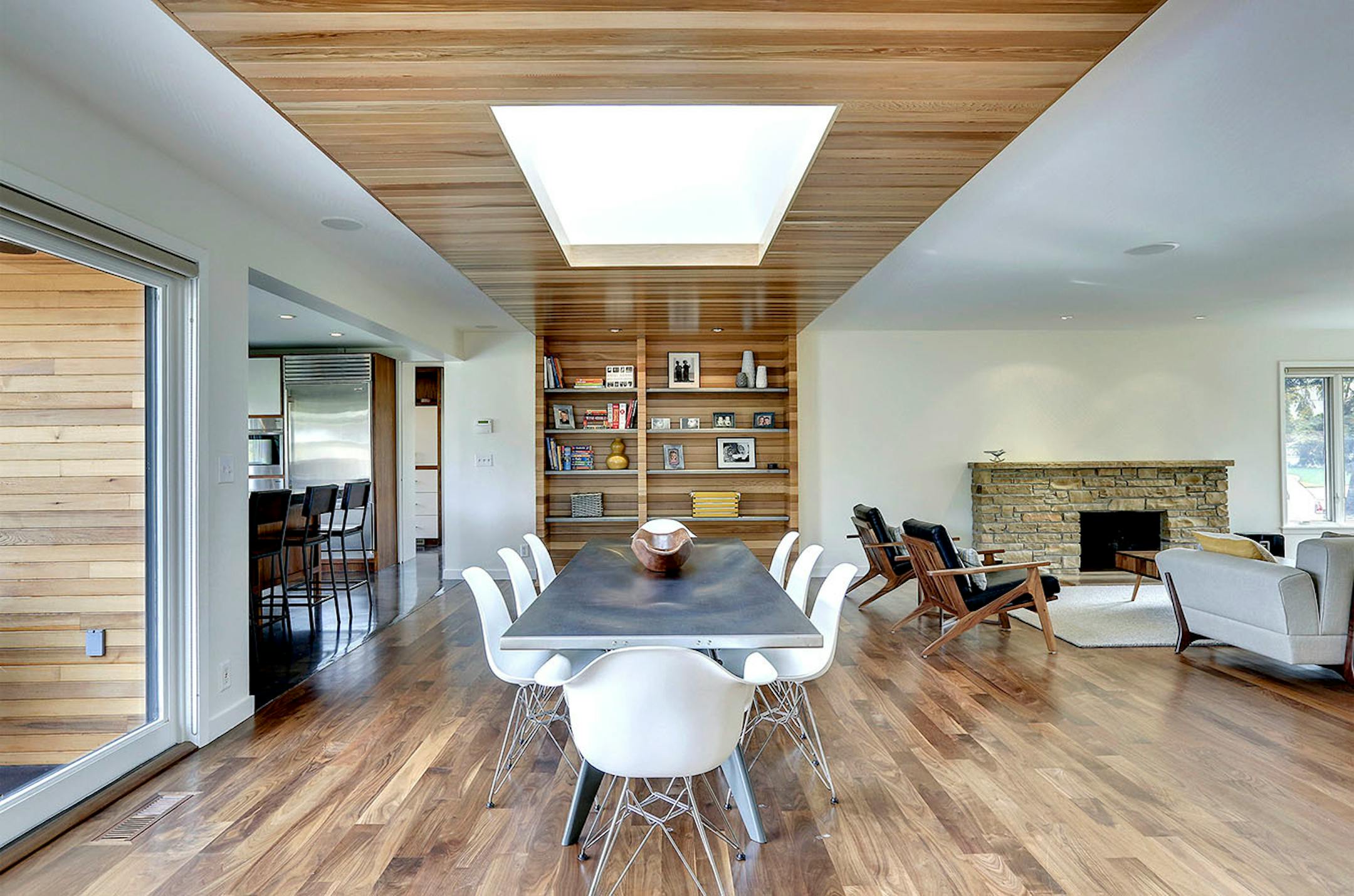 A cedar wrapped skylight is the centerpiece of the refreshed living areas of a 1950s rambler, designed by Peterssen/Keller Architecture.
