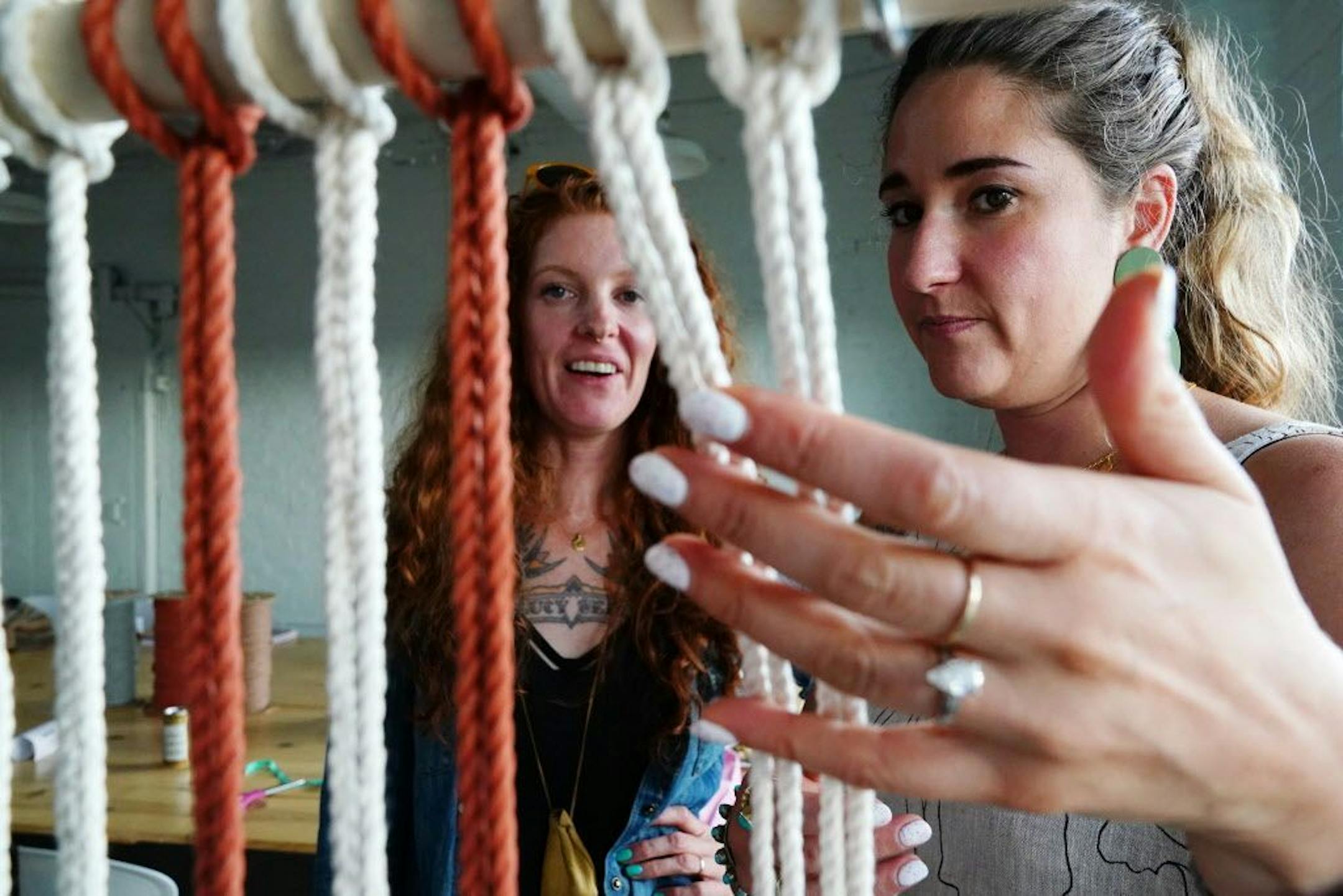 Emily Katz helped Josie Jennings with her macrame project during the class.