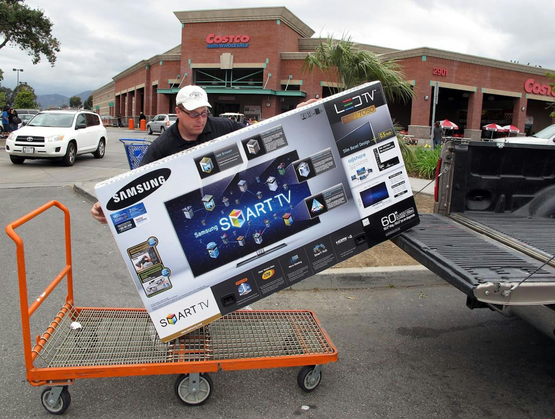 A Costco shopper in Los Angeles loaded a new Samsung TV into his truck. Consumer confidence is at a seven-month high.
