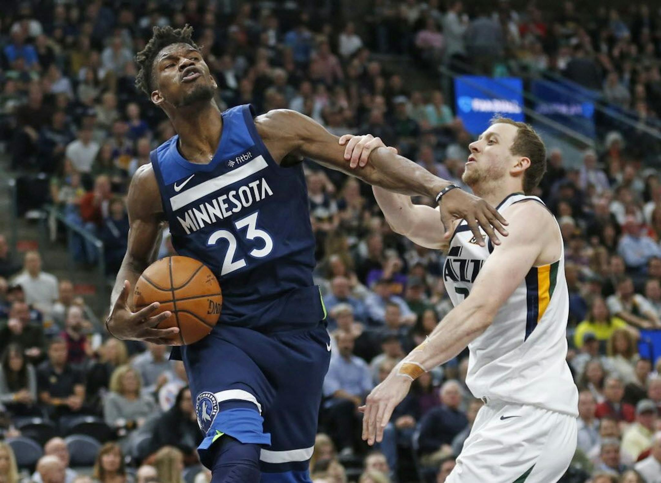 Utah Jazz forward Joe Ingles, right, fouls Minnesota Timberwolves guard Jimmy Butler (23) in the first half during an NBA basketball game Monday, Nov. 13, 2017, in Salt Lake City.