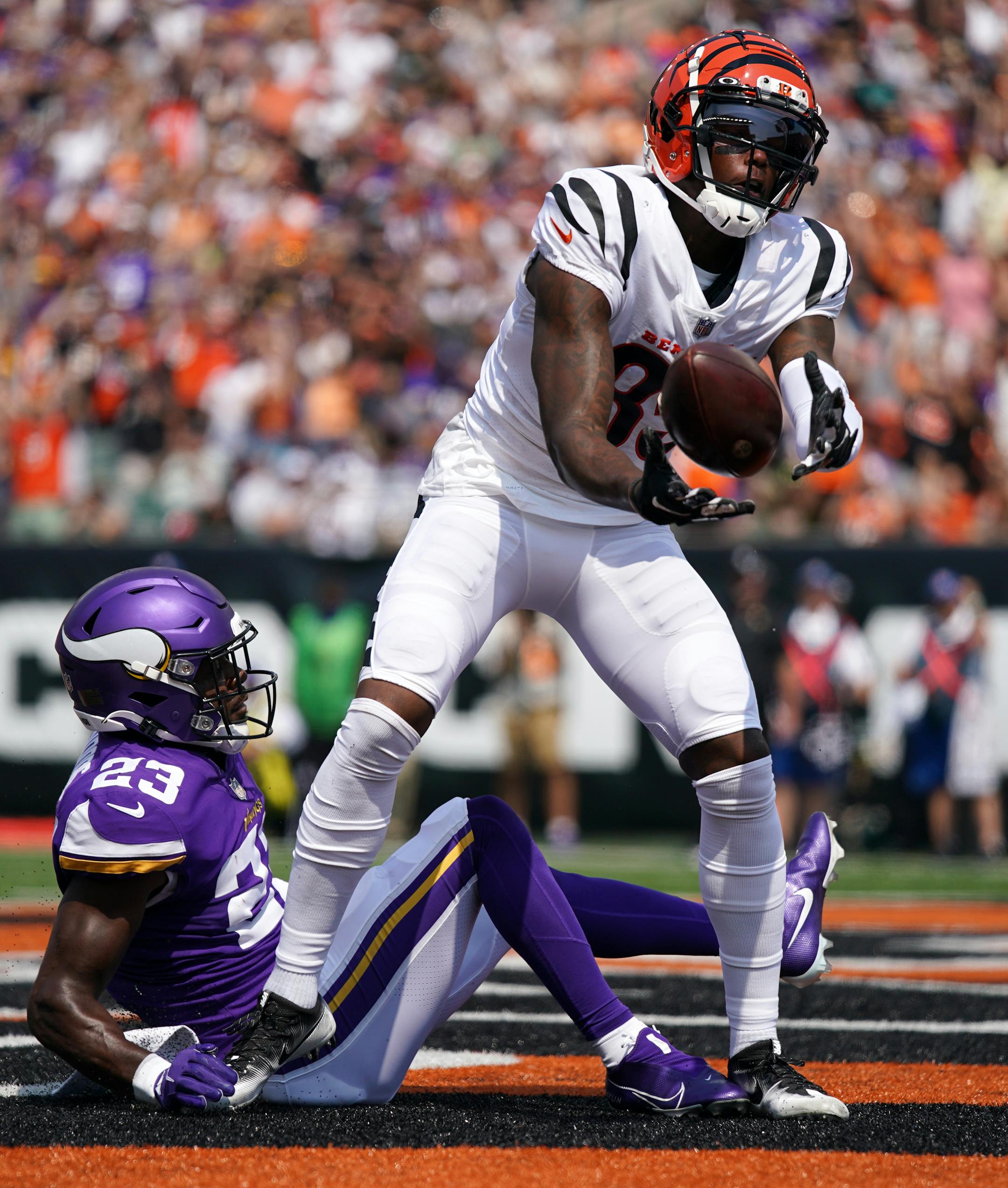 Cincinnati Bengals wide receiver Tee Higgins (85) celebrated a touchdown as Minnesota Vikings free safety Xavier Woods (23) was unable to make the stop in the second quarter.