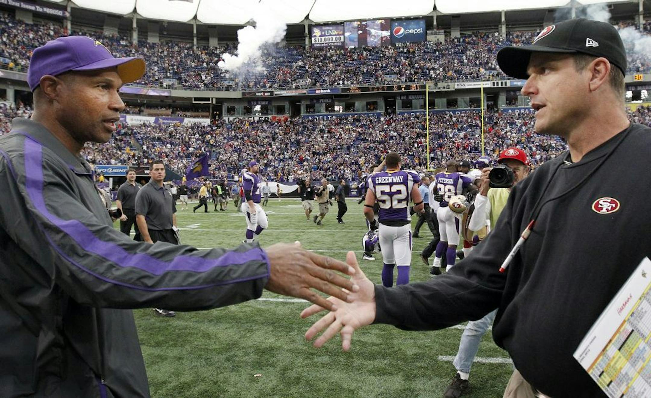 Leslie Frazier shook hand with Jim Harbaugh at the end of the game after Minnesota beat San Francisco 24-13.