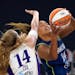Minnesota Lynx forward Napheesa Collier, right, shoots as Los Angeles Sparks' Lauren Cox defends during the first half of a WNBA basketball game Sunda