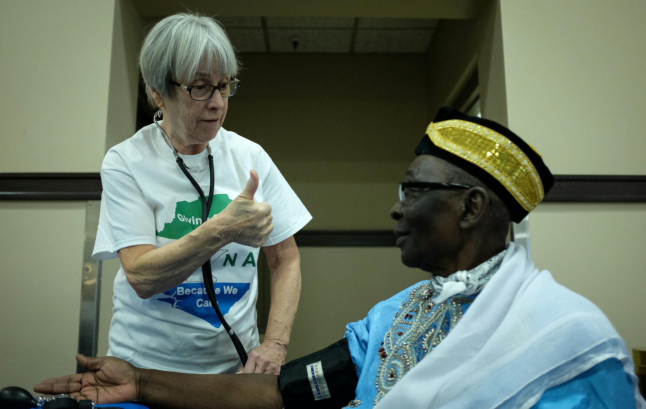 Retired nurse Margaret Sullivan gave the thumbs up to Alpha Yaya Kabba after the results of his blood pressure tests were normal during a free health clinic Friday afternoon. ] AARON LAVINSKY ï aaron.lavinsky@startribune.com A group of nurses from Sierra Leone are banding together to try and get their community to the doctor's office. Known for their "culture of silence," Sierra Leone residents in the north metro often avoid doctors for chronic ailments, suffering for years without seeking