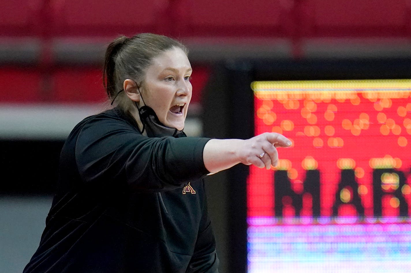 Minnesota head coach Lindsay Whalen talks to her team during the first half of an NCAA college basketball game against Maryland, Saturday, Feb. 20, 2021, in College Park, Md. (AP Photo/Julio Cortez)