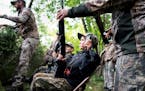 Cameron Talbot, 10, of Andover gets a hand as she prepares to hunt over the Rum River in the Anoka Nature Preserve at the Waterfowl for Warriors youth