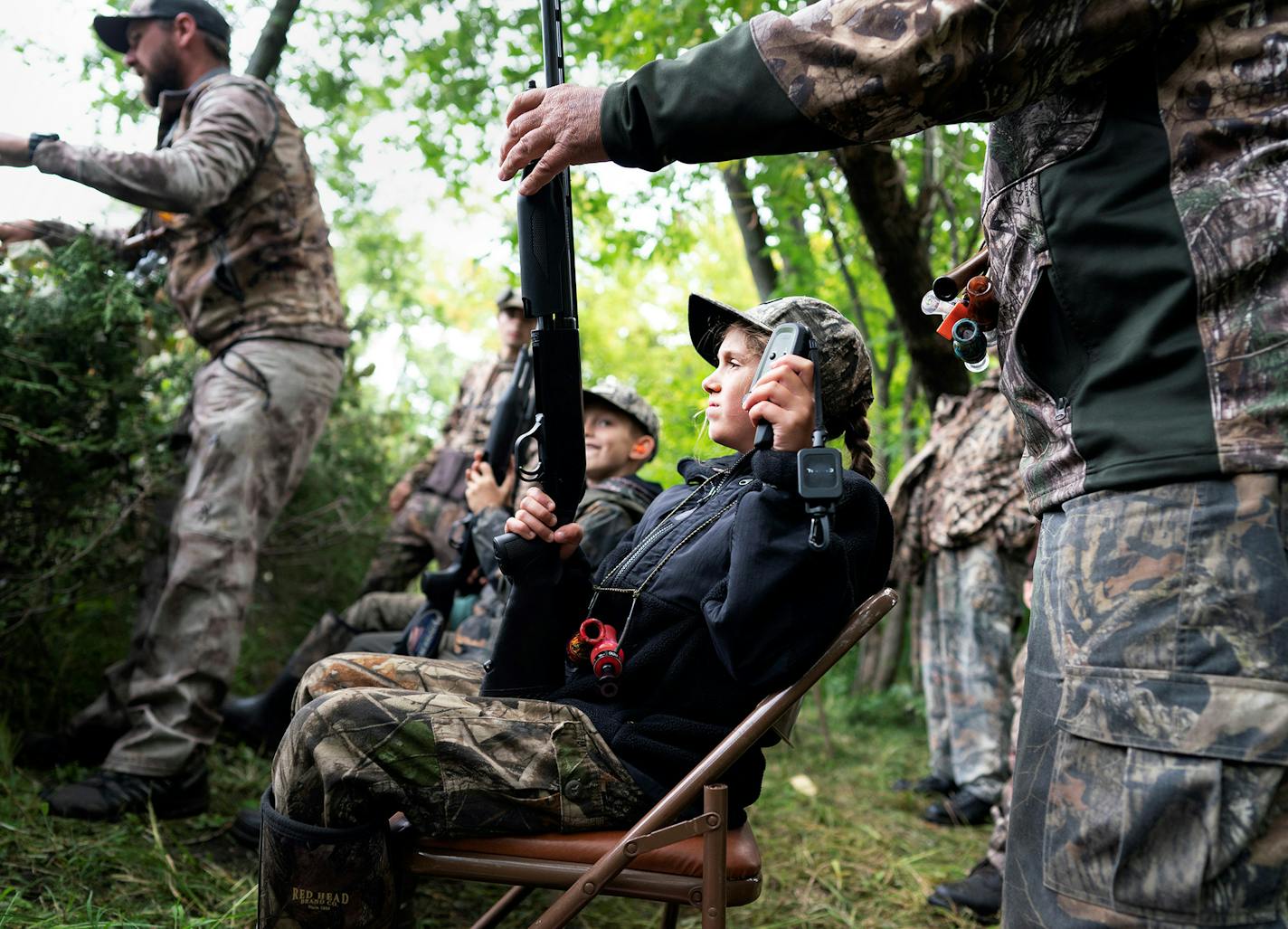 Cameron Talbot, 10, of Andover gets a hand as she prepares to hunt over the Rum River in the Anoka Nature Preserve at the Waterfowl for Warriors youth hunt Saturday September 7, 2019.