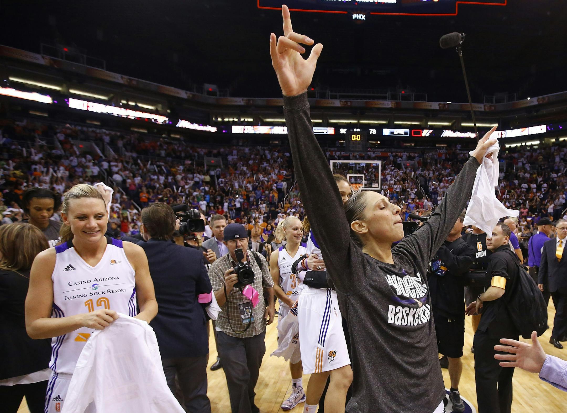 Phoenix Mercury's Diana Taurasi, right, and Penny Taylor, left, celebrate after Game 3 in the WNBA Western Conference basketball finals against the Minnesota Lynx Tuesday, Sept. 2, 2014, in Phoenix. The Mercury defeated the Lynx 96-78, winning the series and advancing to the WNBA Finals. (AP Photo/Ross D. Franklin)
