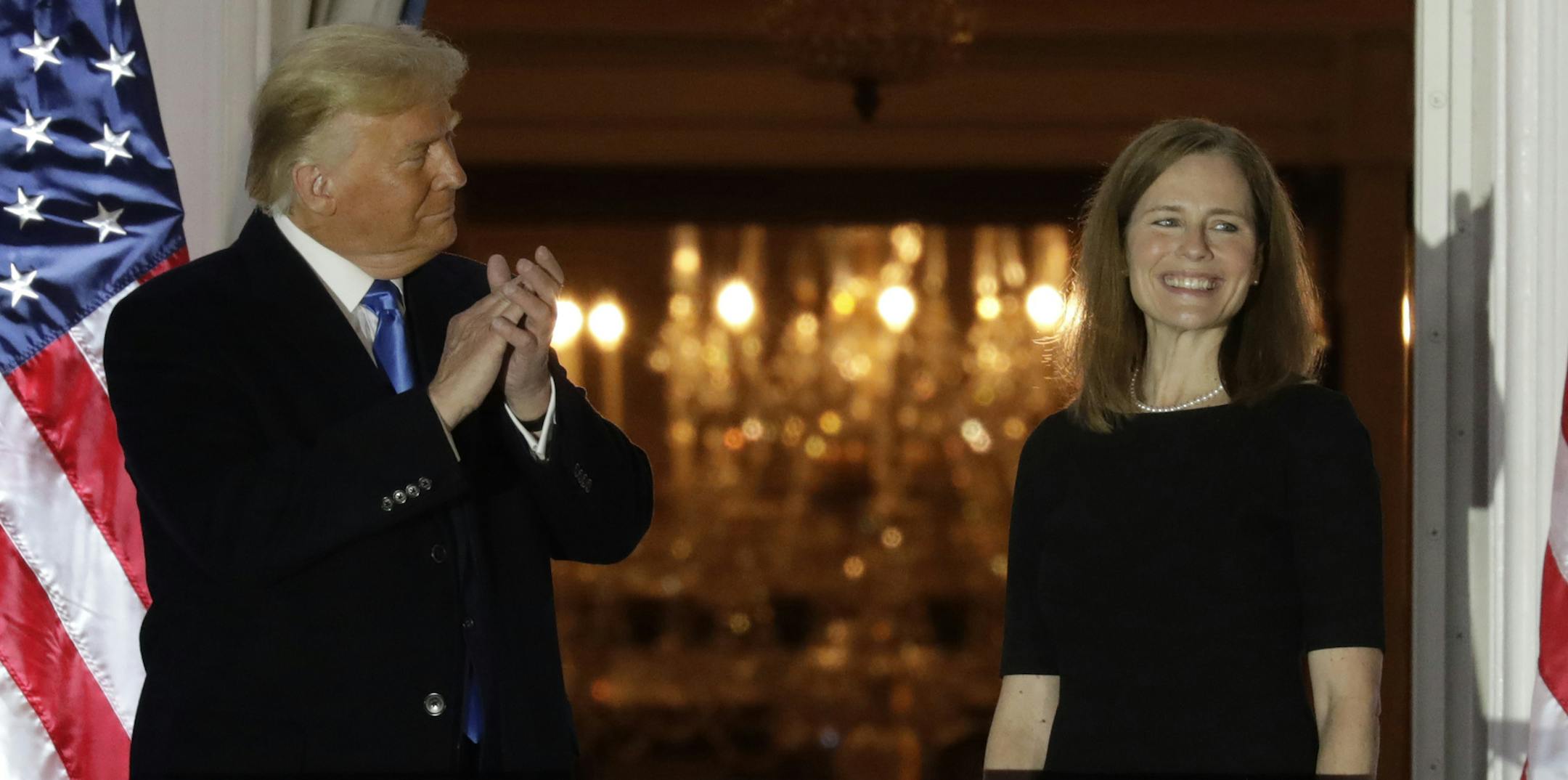 U.S. President Donald Trump applauds new Supreme Court Associate Justice Judge Amy Coney Barrett after she was sworn in during a ceremony on the South Lawn of the White House in Washington, D.C. on Oct. 26, 2020. (Yuri Gripas/Abaca Press/TNS) ORG XMIT: 1807846