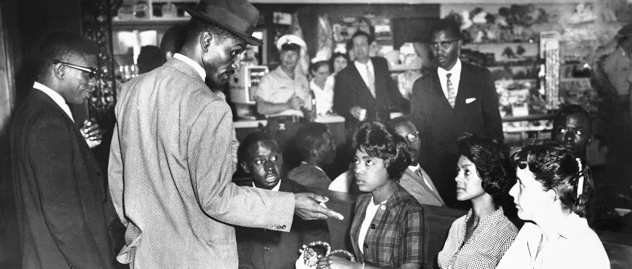 Civil rights protester the Rev. Fred L. Shuttlesworth confers with students, including Catherine Burks-Brooks, left, in the white waiting room of the Birmingham Greyhound station. From the American Experience documentary "Freedom Riders"airing on PBS on May 16, 2011