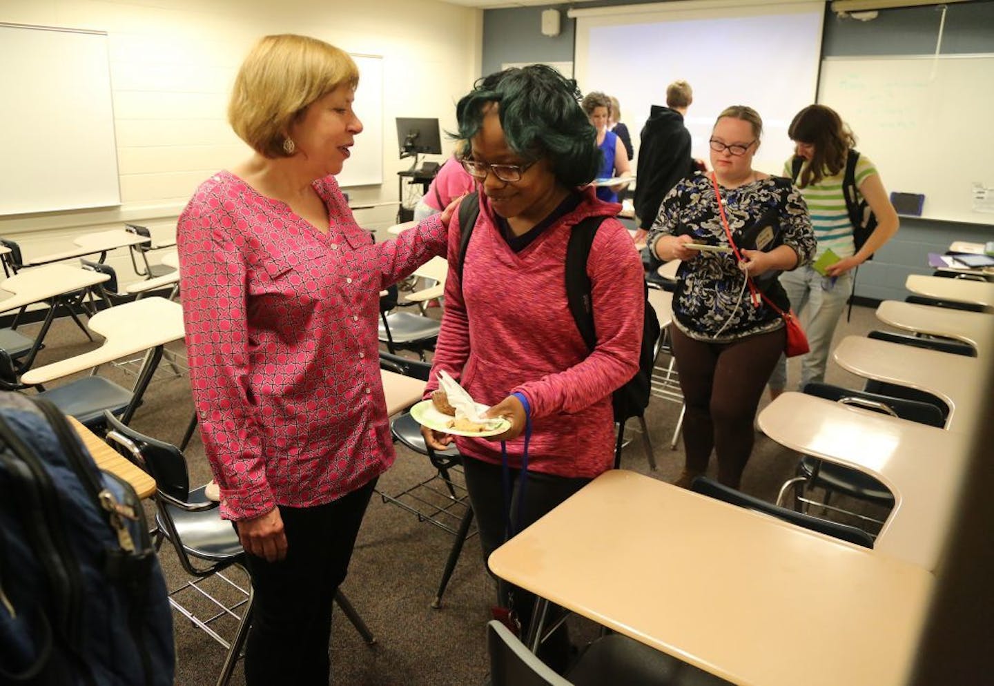 Students who are part of the first class of developmentally-disabled students to graduate from Bethel University took a final exam in "life skills" as part of this unusual program, known as BUILD (Bethel University Inclusive Learning and Development) Thursday, May 25, 2017, in St. Paul, MN. Here, BUILD teacher Diane Iverson, left, says goodbye to her students, including Rita Ikeri, following the program's final class.