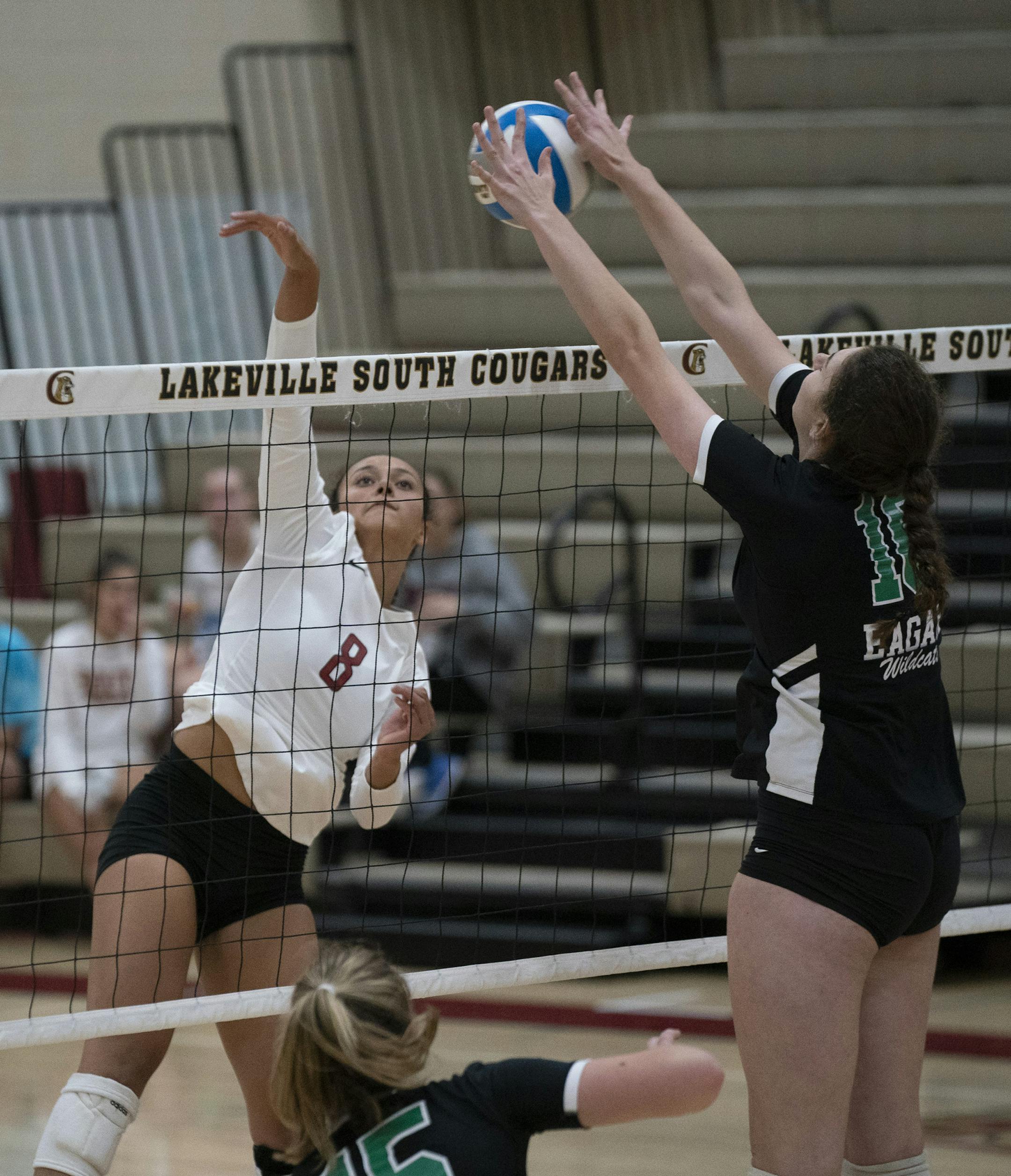 Eagan's Kendall Kemp (16) blocked a shot by Lakeville South's Kendyl Storlie (8) Thursday night. ] JEFF WHEELER • jeff.wheeler@startribune.com The kill shot and the block by some of the best players in the metro when Eagan defeated Lakeville South Thursday night, September 26, 2019, at Lakeville South High School.