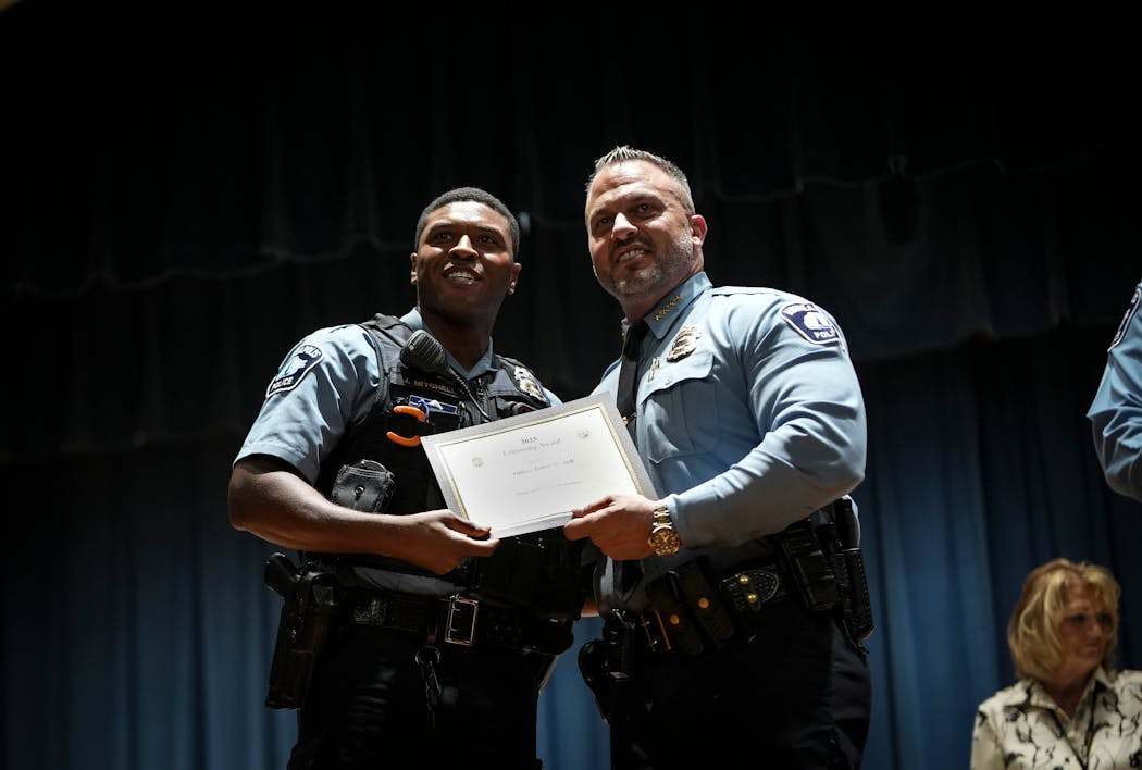 Officer Jamal Mitchell, left, was photographed in a 2023 Minneapolis Police awards ceremony where he was presented with a Lifesaving Award by Chief Brian O’Hara.