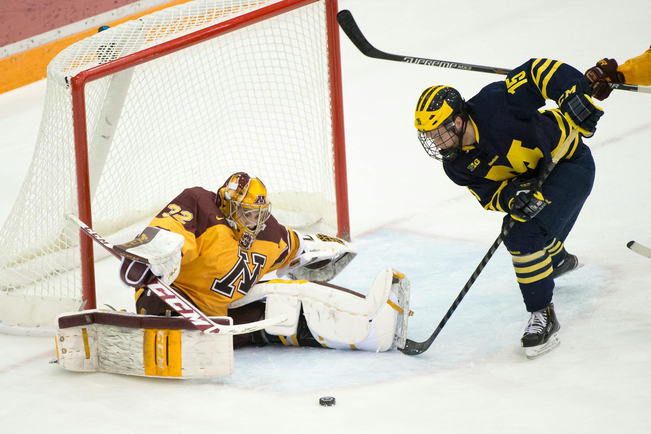 Minnesota goalie Adam Wilcox (32) defends a shot by Michigan right wing Evan Allen (15) during the first period. ] (Aaron Lavinsky | StarTribune) Michigan plays against the University of Minnesota on Saturday, Feb. 14, 2015 at Mariucci Arena.