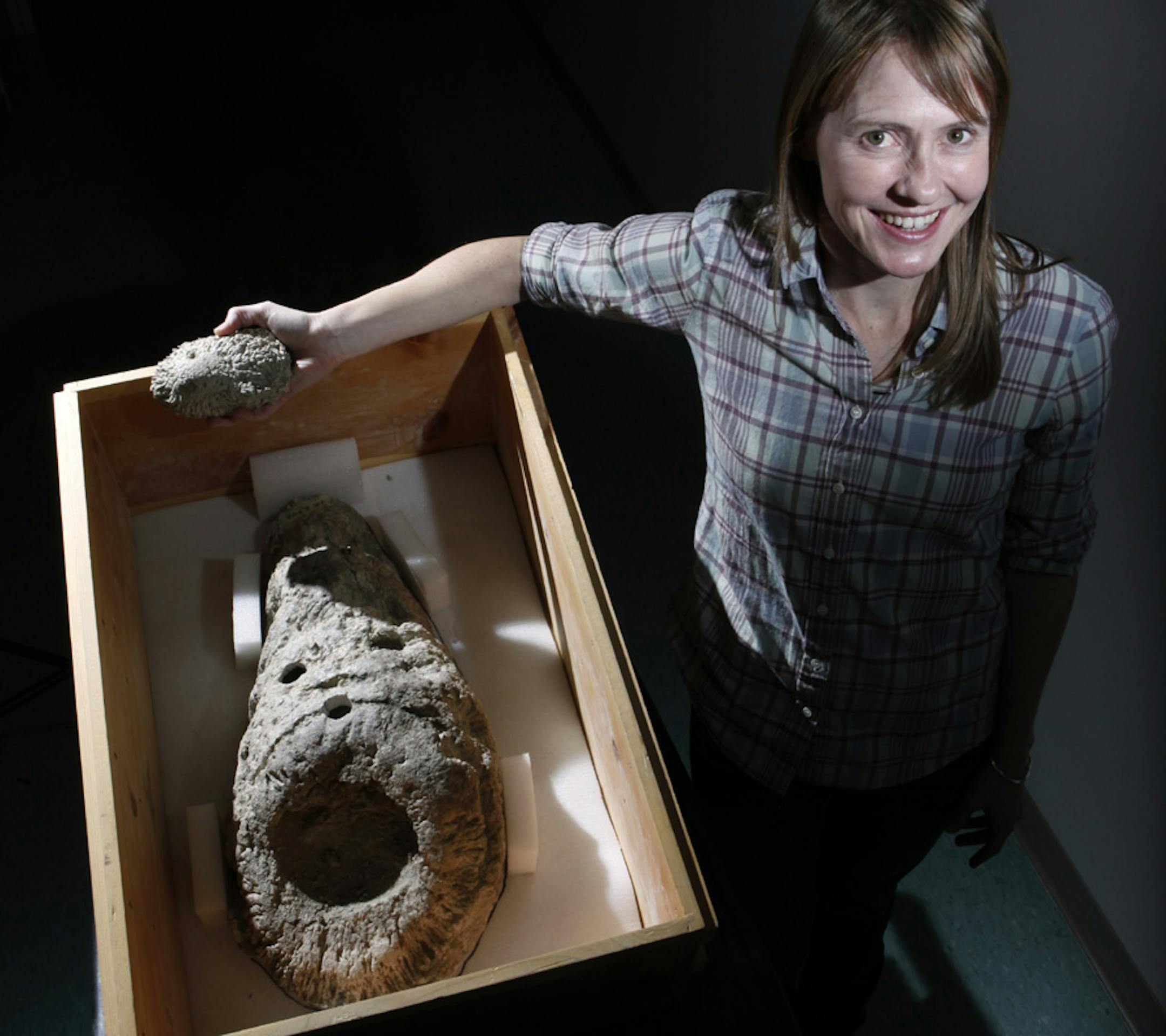 Kristi Curry Rogers with the hollow 65-million-year-old dinosaur bone that may help answer how dinosaurs survived vagaries of weather.