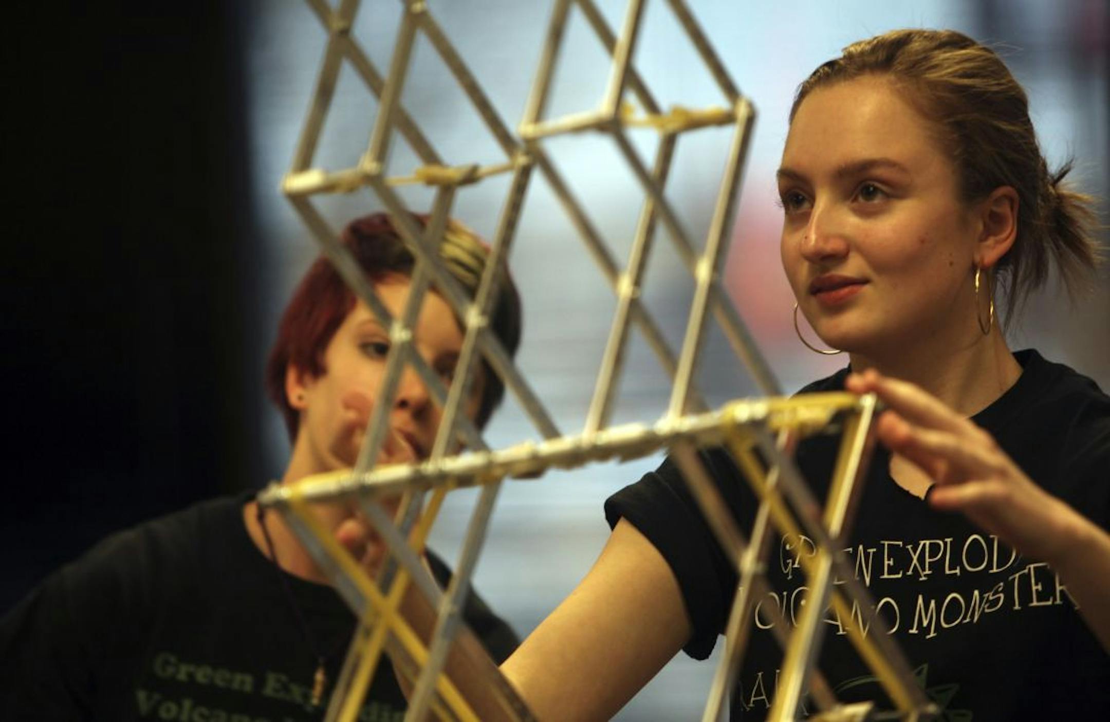 Lilly Bendel-Stenzel, 15, right, and Martina Horns, 14 — part of an all-girl robotics team from Valley View Middle School in Edina called the Green Exploding Volcano Monsters — tried to direct their teammates to straighten out their crooked platform during a demonstration in Richfield.