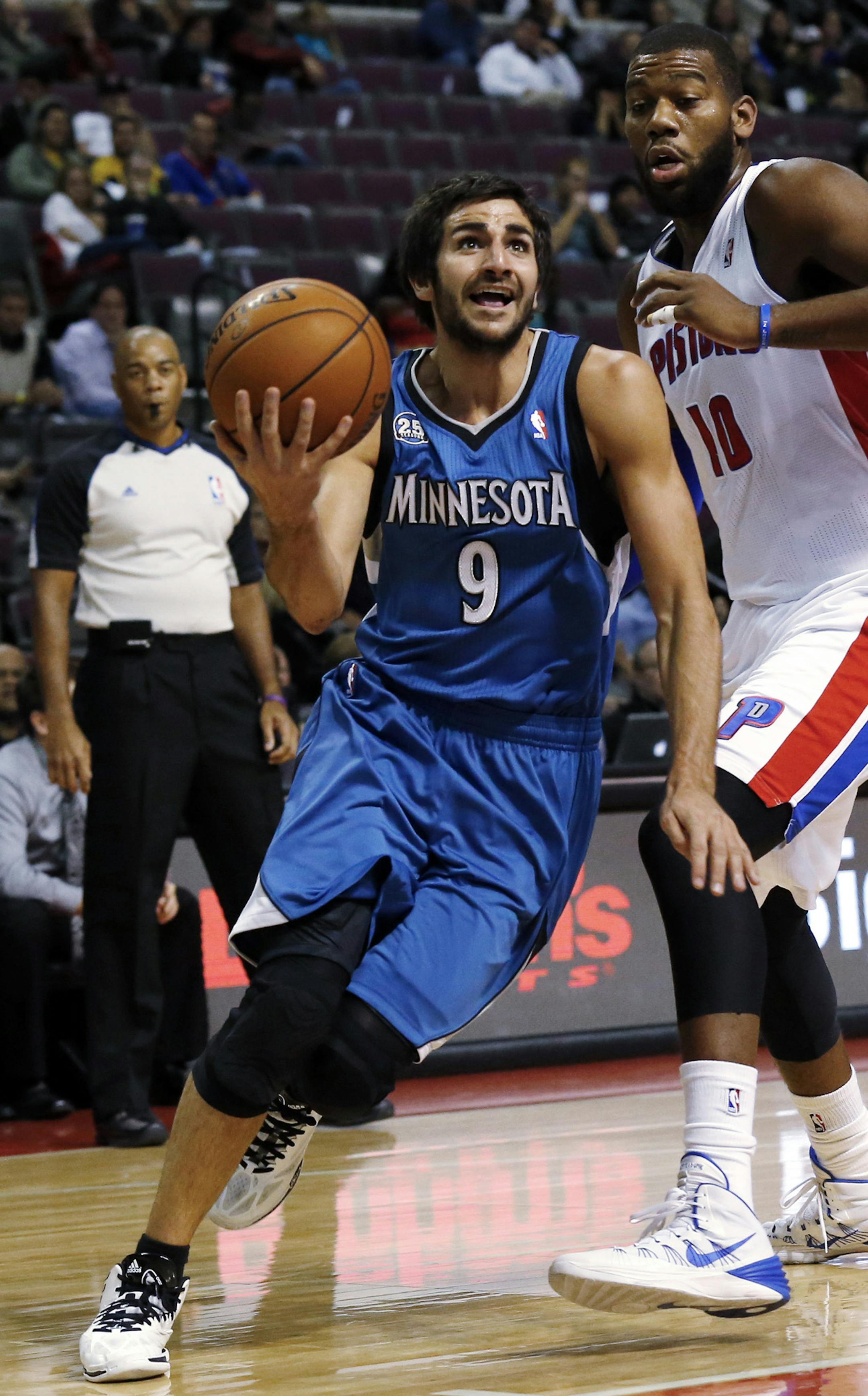 Minnesota Timberwolves point guard Ricky Rubio (9), of Spain, drives against Detroit Pistons center Greg Monroe (10) in the first half of their preseason NBA basketball game in Auburn Hills, Mich., Thursday, Oct. 24, 2013. (AP Photo/Paul Sancya) ORG XMIT: MIPS101