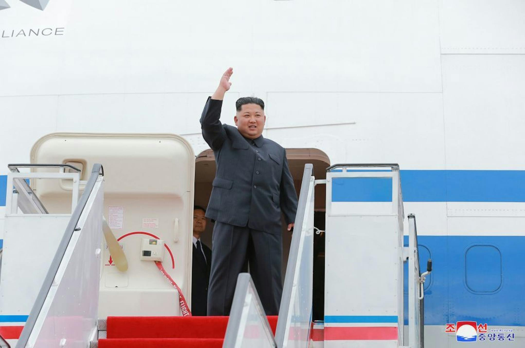 In this Sunday, June 10, 2018, photo provided by the North Korean government, North Korean leader Kim Jong Un, center, waves as he leaves for Singapore, at Pyongyang international airport in Pyongyang, North Korea. Independent journalists were not given access to cover the event depicted in this image distributed by the North Korean government. The content of this image is as provided and cannot be independently verified. Korean language watermark on image as provided by source reads: "KCNA" whi