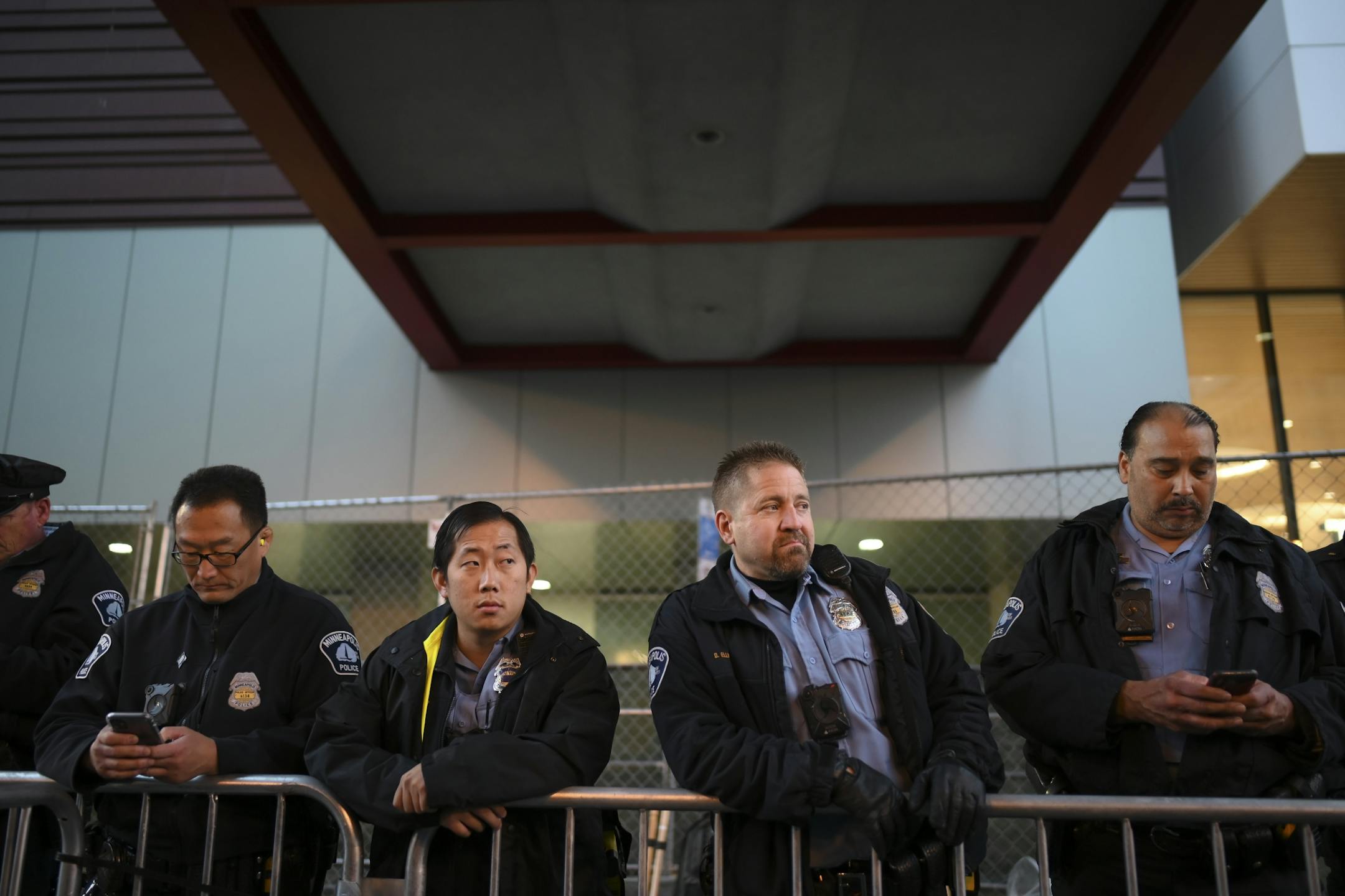 Minneapolis Police officers watched and waited outside Target Center near where anti-Trump protesters and Trump supporters were facing off.