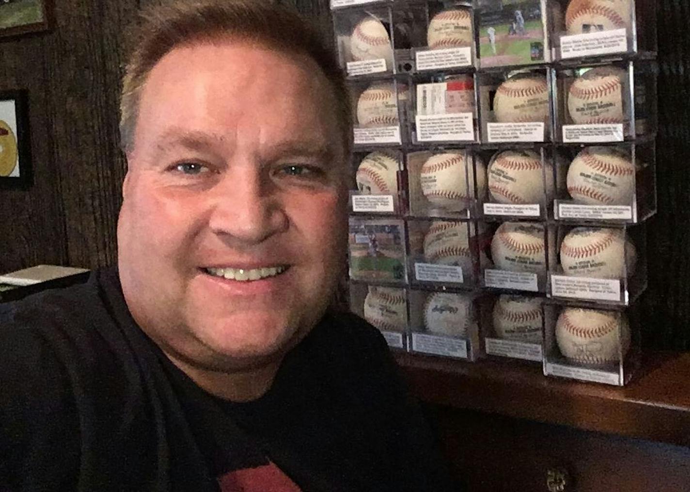 Jason Gabbert, 49, of Plymouth, with a partial collection of baseballs he has amassed attending Major League Baseball games.