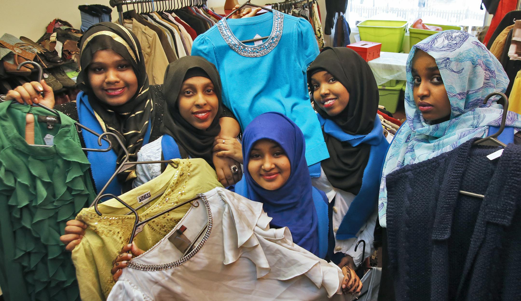 Sixteen girls of African descent have opened a clothes boutique in the Cedar-Riverside area that is funded by a number of area businesses and schools. Zikriyat Adam, Fadumo Hashi, Maryan Farah, Khadra Fiqi and Maryama Abdulkadir, l-r, displayed some of the clothes for sale in the boutique. ] (MARLIN LEVISON/STARTRIBUNE(mlevison@startribune.com)