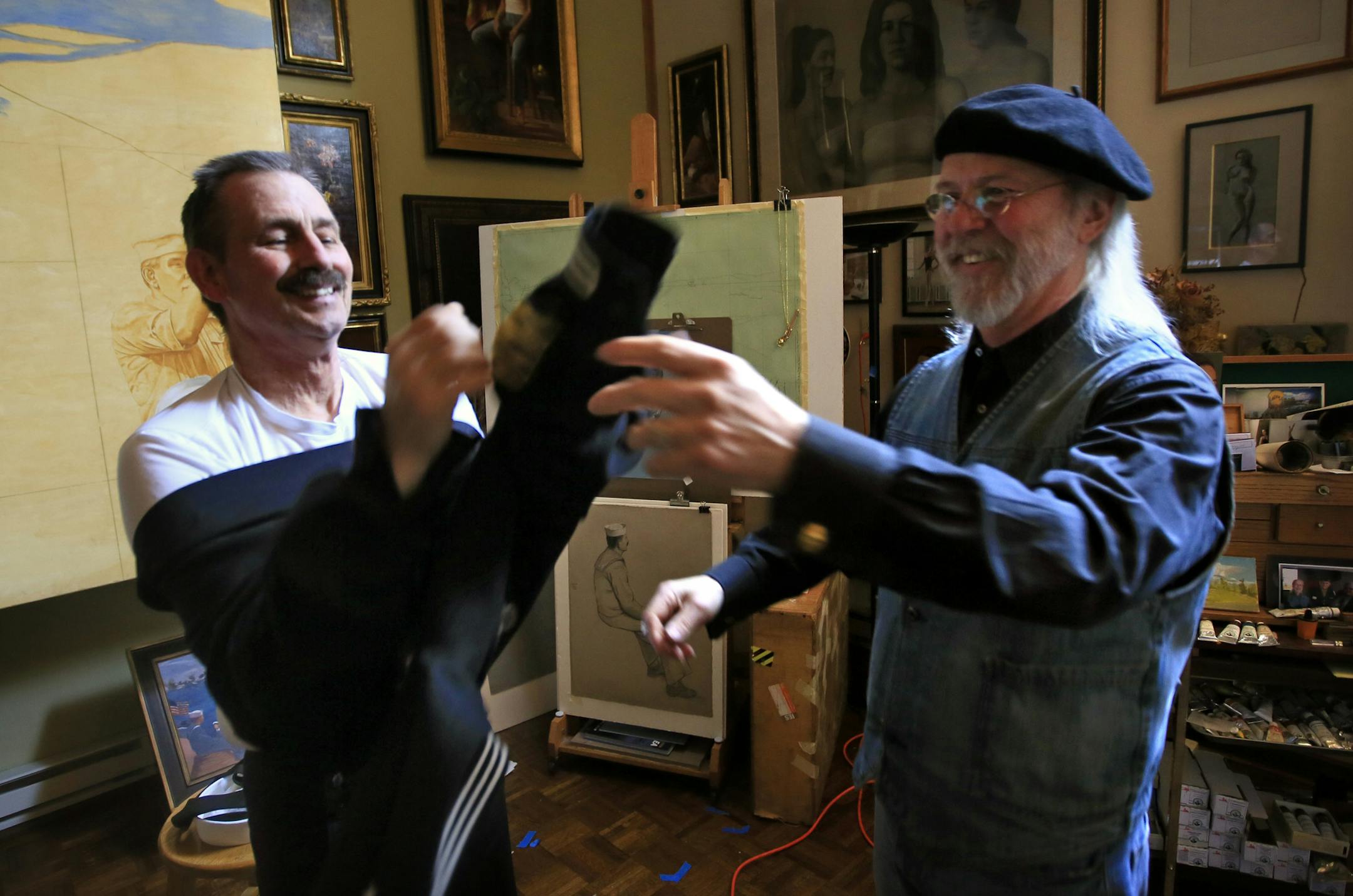 Ray Stumpf, a Navy veteran and retired school teacher is dying of cancer, he is spending his final months decked out in naval gear and sitting as the model for "the lone sailor" in one of Charles Kapsner's military paintings. Here, Kapsner helps Stumpf get into his uniform before sitting. ] BRIAN PETERSON &#x2022; brianp@startribune.com
Little Falls, MN - 02/27/2012