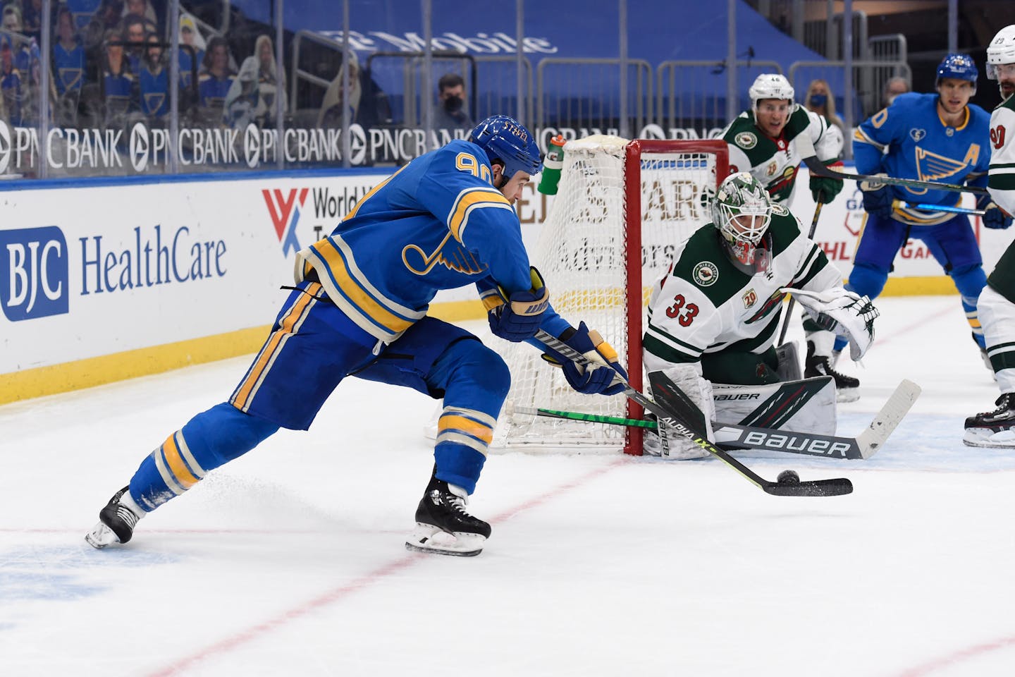 St. Louis Blues' Ryan O'Reilly (90) scores the winning goal past Minnesota Wild's Cam Talbot (33) during overtime of an NHL hockey game on Saturday, April 10, 2021, in St. Louis. (AP Photo/Joe Puetz)