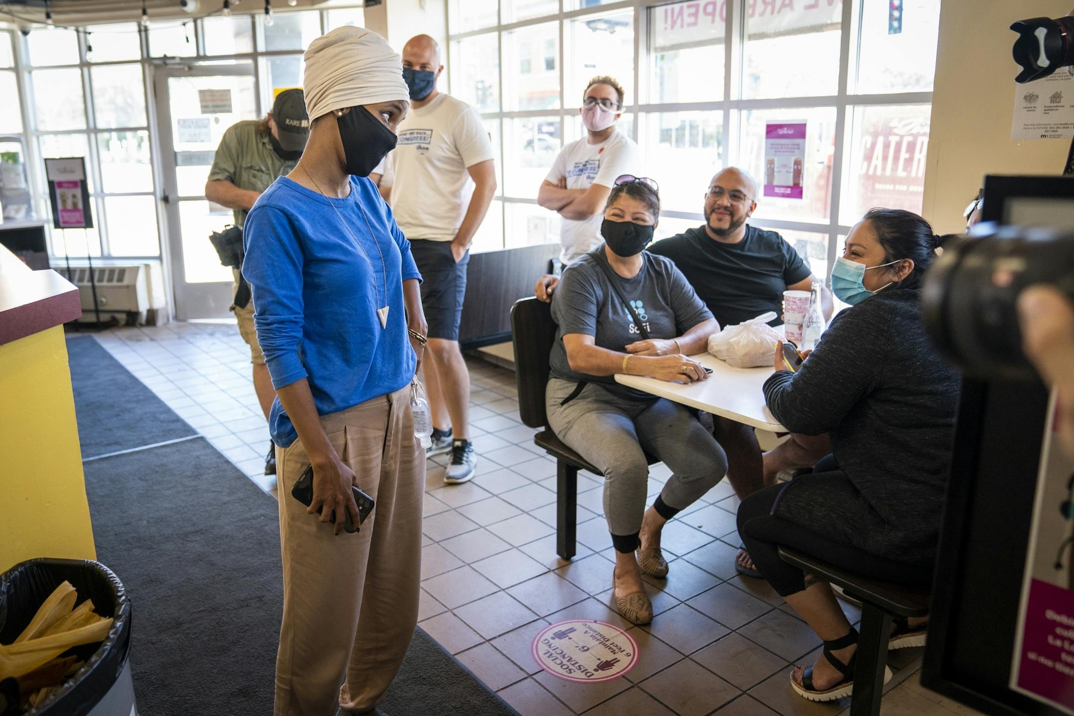 U.S. Rep. Ilhan Omar talked to a group of diners during a get out the vote stop on Primary Election Day at Mercado Central in Minneapolis.