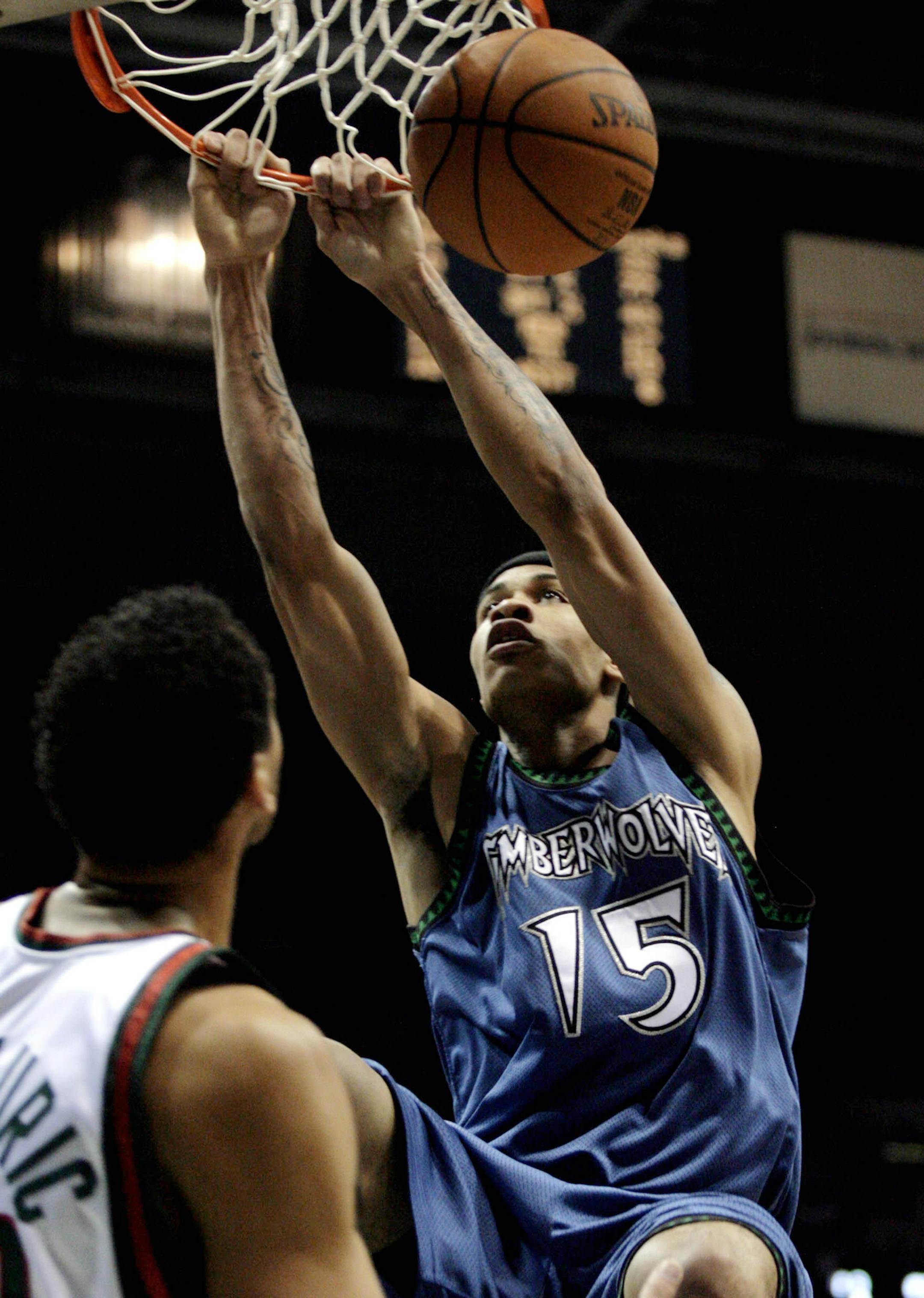 Minnesota Timberwolves' Gerald Green, right, hangs on the rim after a slam dunk against the Milwaukee Bucks in the first half of a preseason basketball game Saturday Oct. 20, 2007, in Milwaukee. (AP Photo/Darren Hauck) ORG XMIT: WIDH103 ORG XMIT: MIN2014022818151558