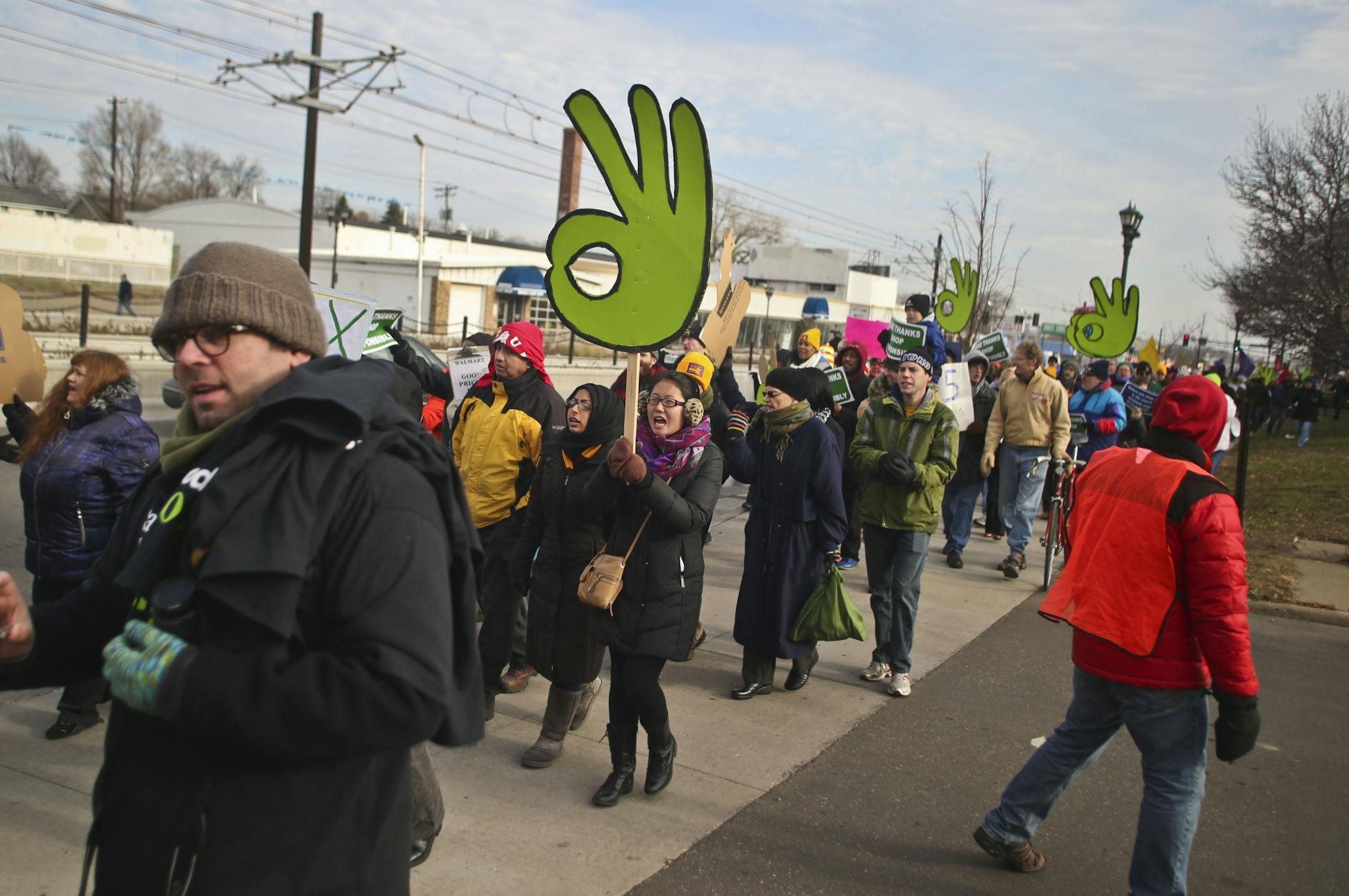 A large crowd of people marched along University Avenue in St. Paul, Minn. near a Super Target protesting cleaning workers working conditions and wages on Friday, November 29, 2013.