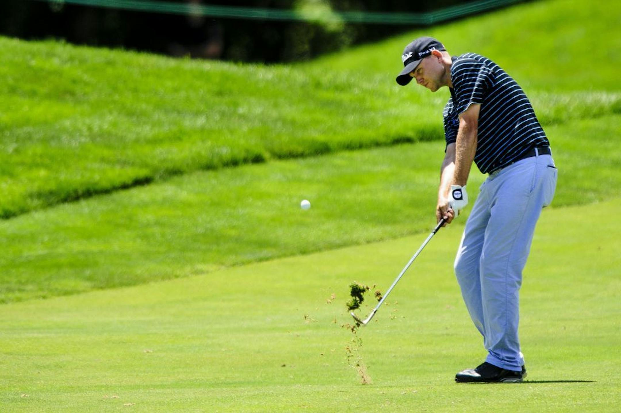 Bill Haas hits his approach shot on the par-5 sixth hole during the third round of the AT&T National at Congressional Country Club in Bethesda, Maryland, Saturday, June 29, 2013.