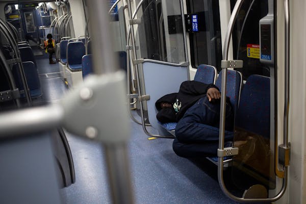 A man sleeps on the Green Line train early in the morning Friday, August 16, 2019. ] NICOLE NERI &#x2022; nicole.neri@startribune.com