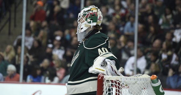 Minnesota Wild goalie Devan Dubnyk (40) watches during a break in the second period of an NHL hockey game against the Arizona Coyotes Saturday, Jan. 1