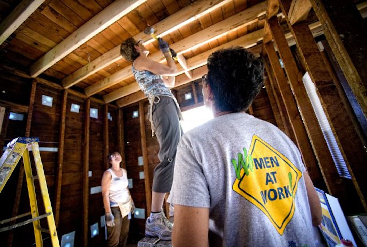 WomenBuild crew leader Sharon Pfeiffer, right, helped Maggie Gilbert, left, and Catherine Shreves work on support beams in a Habitat for Humanity house on Emerson Avenue N. in Minneapolis.