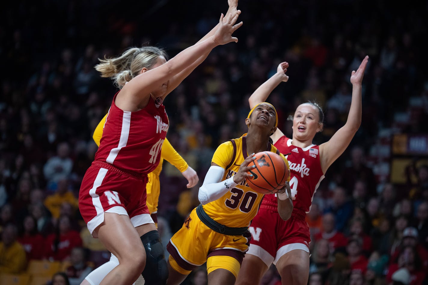 Minnesota Golden Gophers guard Janay Sanders (30) drives to the basket on Nebraska Cornhuskers center Alexis Markowski (40) and guard Callin Hake (14) in the first half at Williams Arena Sunday January ,14 2024 in, Minneapolis ,Minn. ] JERRY HOLT • jerry.holt@startribune.com