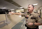 Anoka County Jail Commander Dave Pacholl demonstrates how a new iris scanning system works in the release station at the Anoka County Jail October 13,