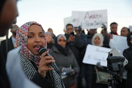 FILE- Ilhan Omar, then soon to be sworn in as a U.S. Representative, joined Somali leaders and other community members gathered outside the Amazon ful