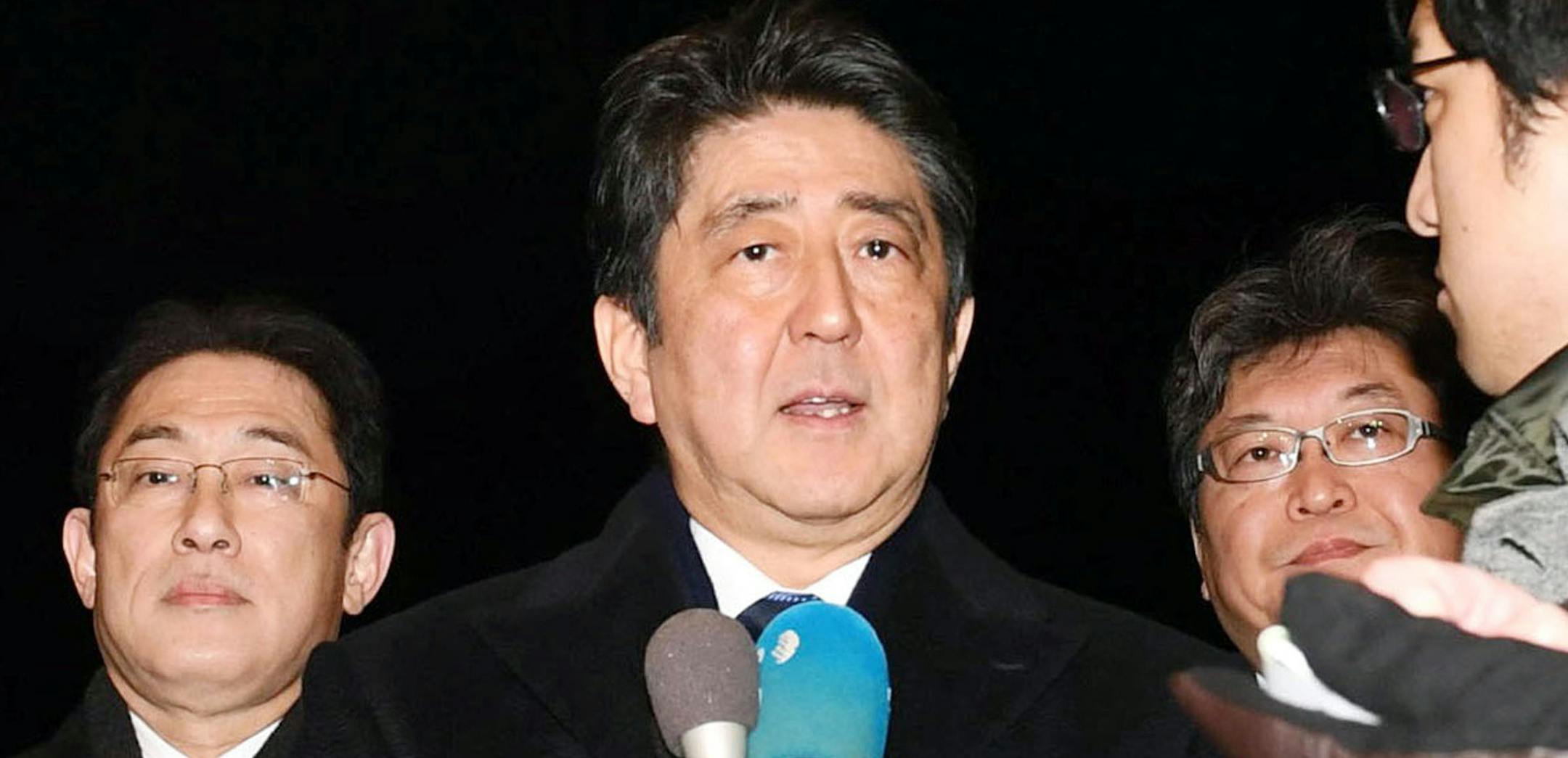 Japanese Prime Minister Shinzo Abe, center, speaking to reporters at Haneda international airport in Tokyo on Thursday before leaving for the United States.