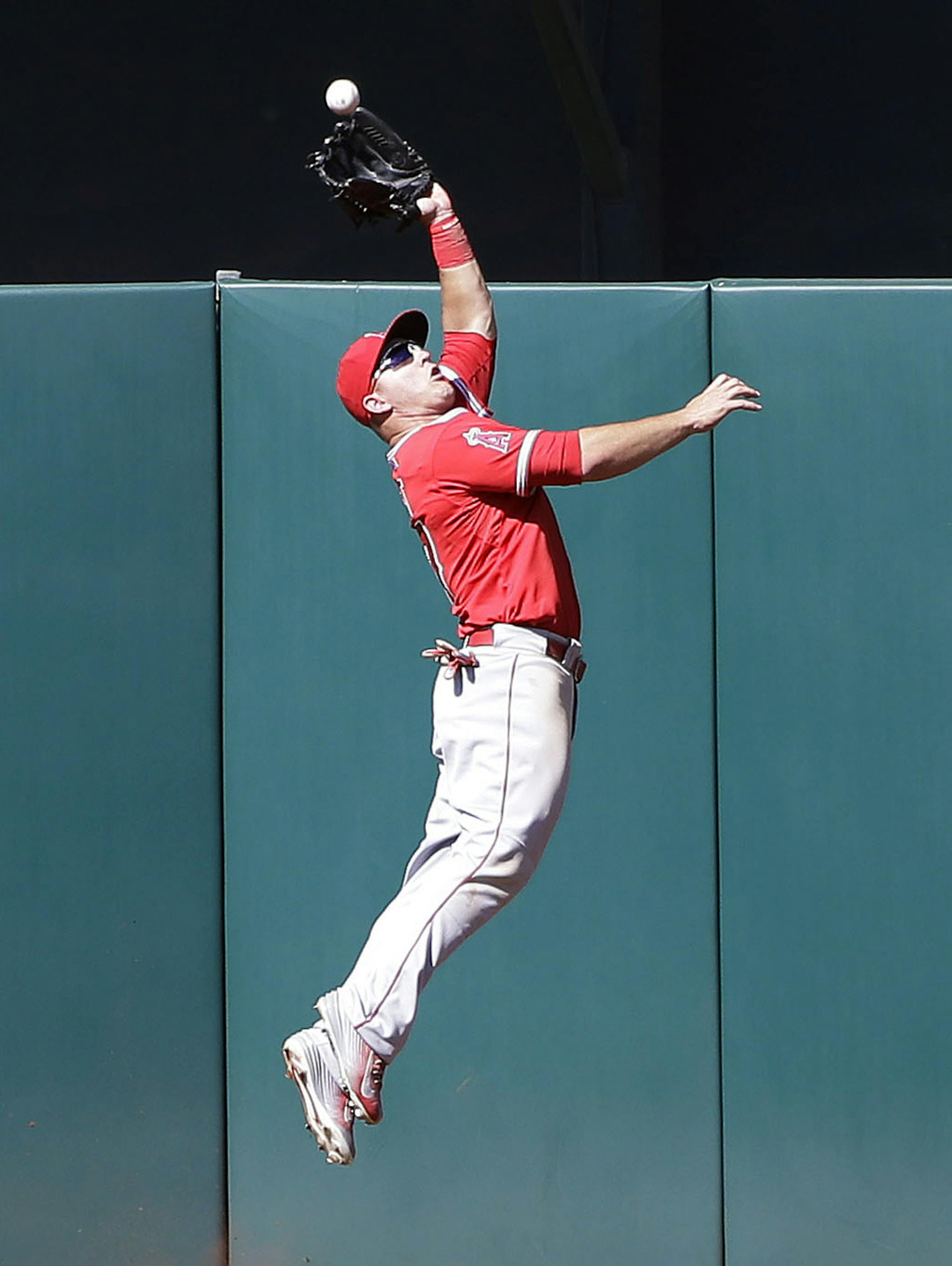 Los Angeles Angels center fielder Mike Trout makes a leaping catch for last out of the game on a fly ball from Oakland Athletics' Ike Davis during the ninth inning of a baseball game Thursday, April 30, 2015, in Oakland, Calif. Los Angeles won 6-5. (AP Photo/Marcio Jose Sanchez)