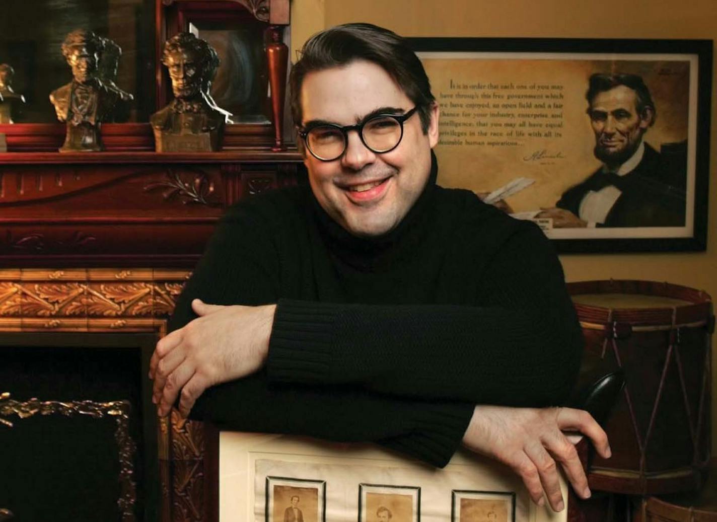 photo of author James L. Swanson in front of photo of Abraham Lincoln and fireplace